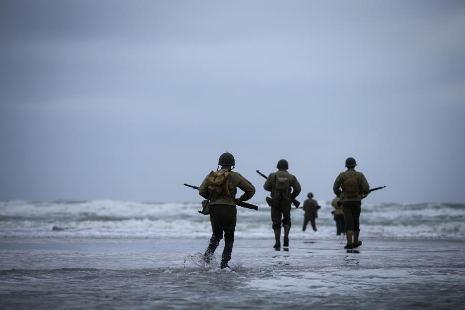 FILE - World War II reenactors walk on Omaha Beach in Saint-Laurent-sur-Mer, Normandy, France, June 6, 2023. France is getting ready to show its gratitude towards World War II veterans who will come, many for the last time, on Normandy beaches for D-Day ceremonies that will come as part of a series of major commemorations this year and next marking eight decades since the defeat of the Nazis. (AP Photo/Thomas Padilla, File)