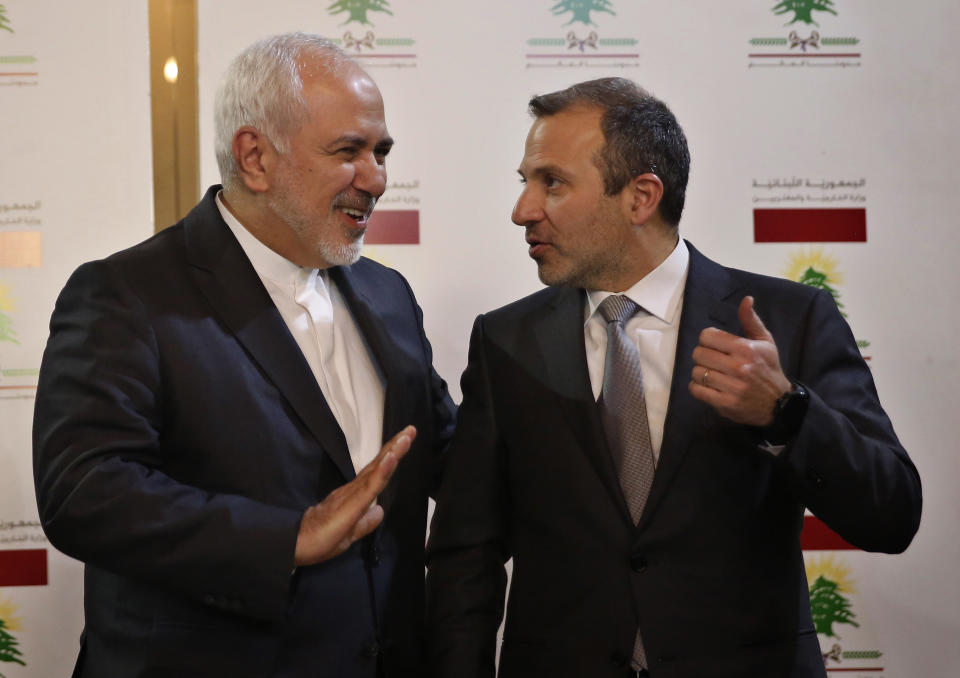 Lebanese Foreign Minister Gebran Bassil, right, speaks with his Iranian counterpart Mohammad Javad Zarif, in Beirut, Lebanon, Monday, Feb. 11, 2019. Zarif extended an offer for Iranian military assistance to the U.S.-backed Lebanese army on Sunday, saying Iran is ready to assist in all sectors should the Lebanese government want it. (AP Photo/Hussein Malla)