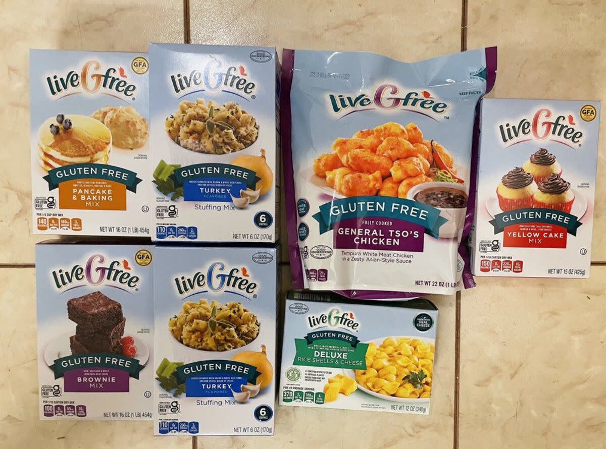 7 boxes of different kinds of Aldi’s gluten-free brand liveGfree foods, on large beige tiles