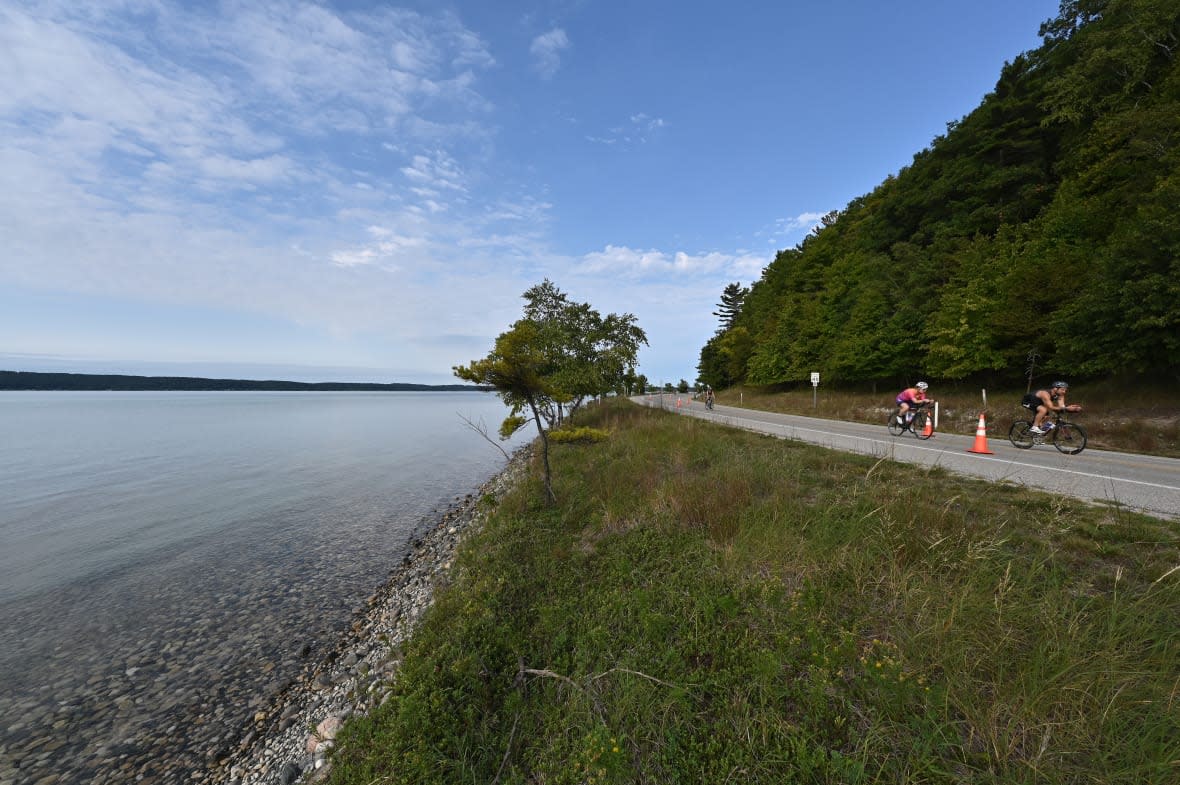 People cycle alongside Crystal Lake on September 12, 2021 in Frankfort, Michigan. (Photo by Jamie Sabau/Getty Images for IRONMAN)