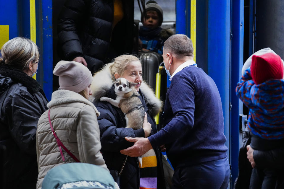 People fleeing the conflict from neighboring Ukraine arrive to Przemysl train station in Przemysl, Poland, on Friday, Feb. 25, 2022. (AP Photo/Petr David Josek)