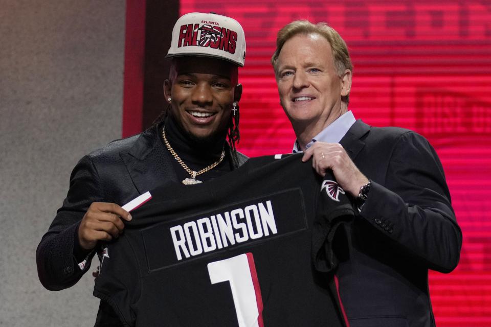 Texas running back Bijan Robinson, left, poses with NFL Commissioner Roger Goodell after being chosen by the Atlanta Falcons with the eighth overall pick during the first round of the NFL football draft, Thursday, April 27, 2023, in Kansas City, Mo. | Jeff Roberson, Associated Press