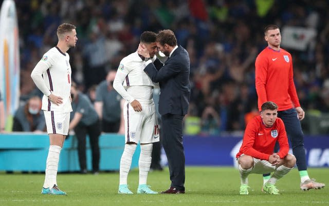 Gareth Southgate (right) consoles Jadon Sancho after the shootout defeat 