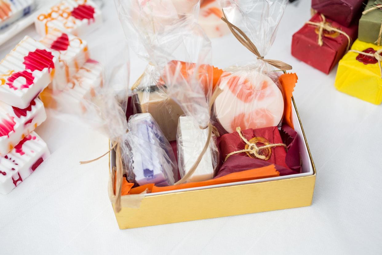 Gift basket of wrapped hand made soap on white cloth