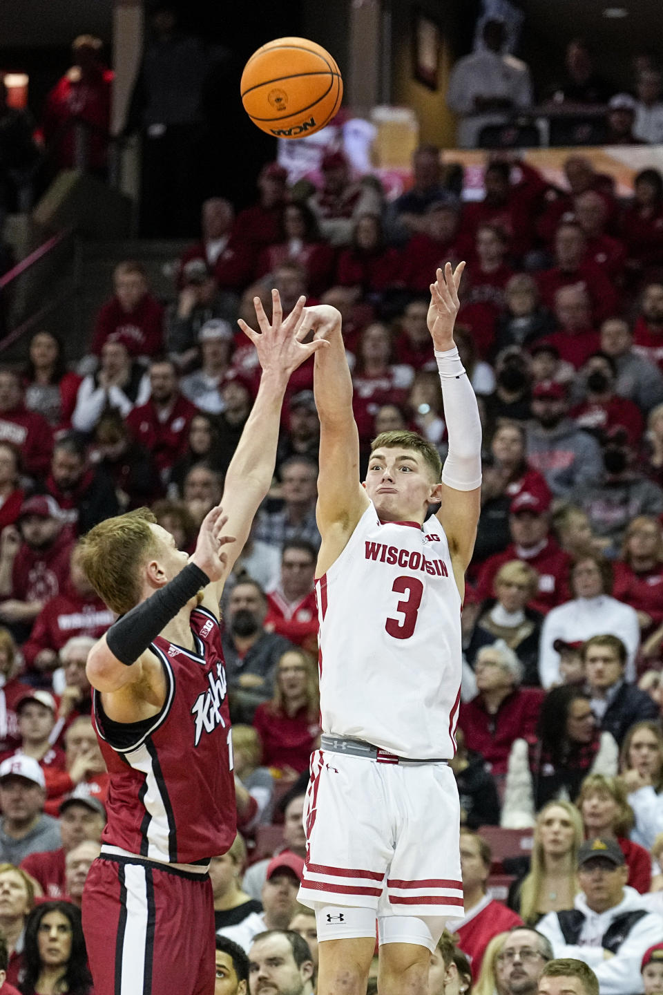 Wisconsin's Connor Essegian (3) shoots over Rutgers' Oskar Palmquist (1) during the second half of an NCAA college basketball game Saturday, Feb. 18, 2023, in Madison, Wis. (AP Photo/Andy Manis)