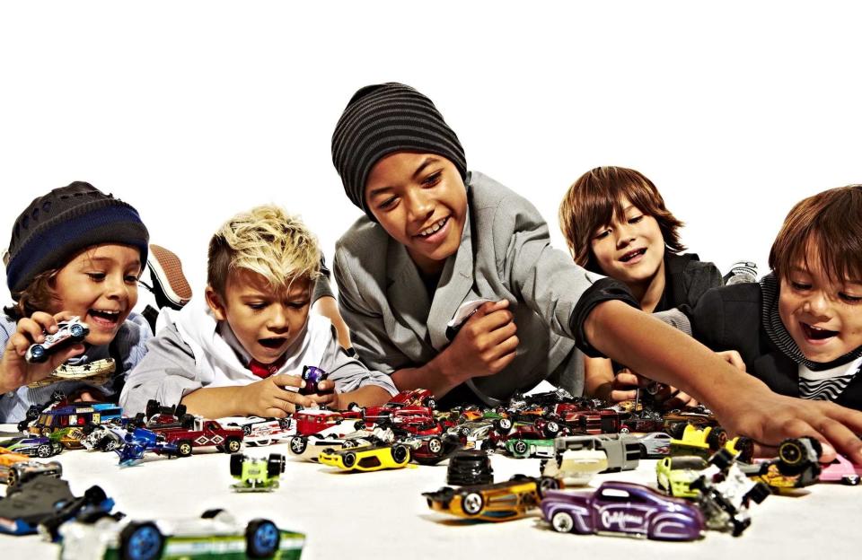 kids playing with hot wheel cars of various colors