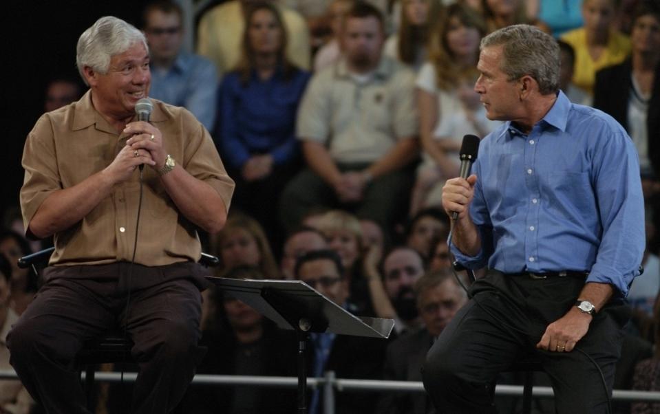 George Puentes shares the stage with President George W. Bush in August 2004 at Southridge High School in Beaverton, talking about how the president's tax cuts helped him reinvest in his tortilla making business.