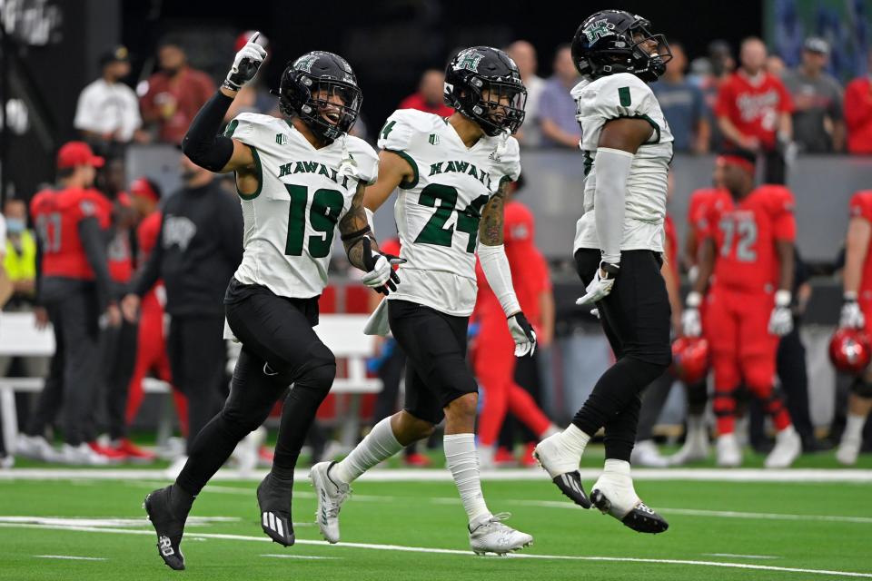 Hawaii's Quentin Frazier (19) and Kai Kaneshiro (24) celebrate an interception against UNLV on Nov. 13.