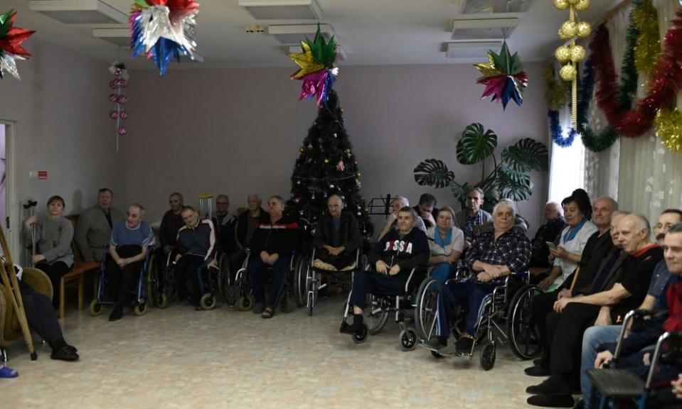 Residents and employees of a nursing home gather to watch a performance organized by volunteers on the occasion of the Christmas holidays.