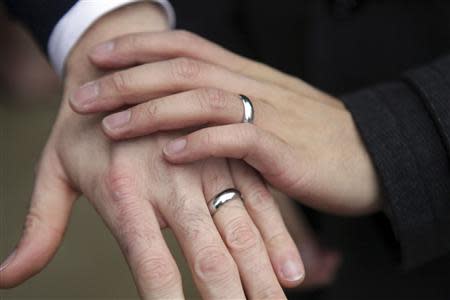 A same-sex couple show their rings after getting married outside Seattle City Hall in Seattle, Washington in this file photo taken December 9, 2012. REUTERS/Cliff Despeaux/Files