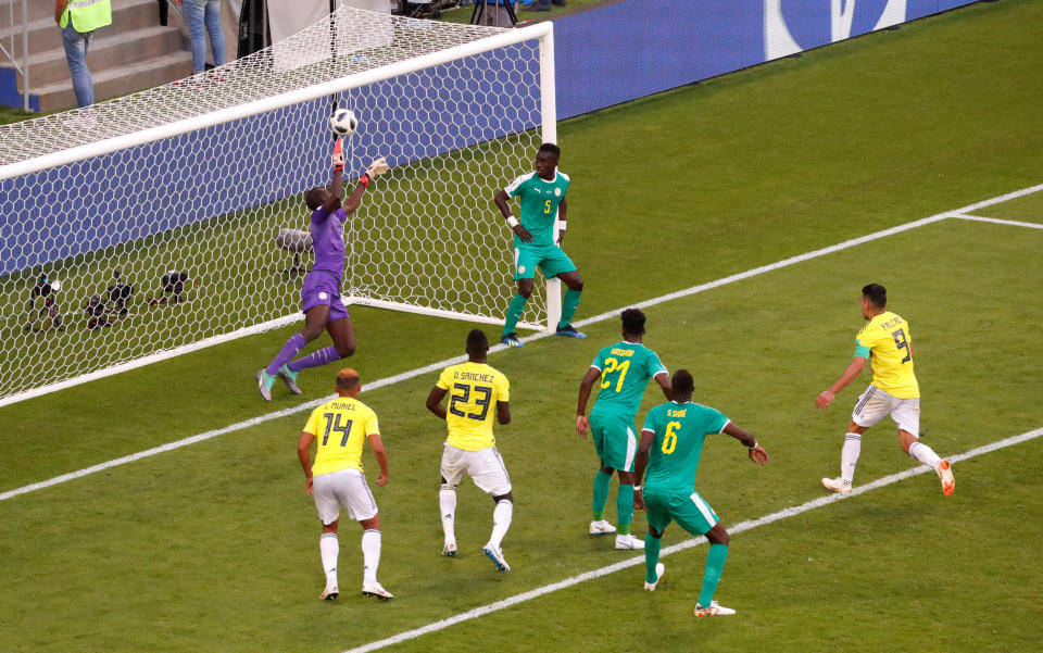 <p>Colombia’s Yerry Mina puts the ball past the despairing Khadim Ndiaye as Colombia took a 1-0 lead </p>