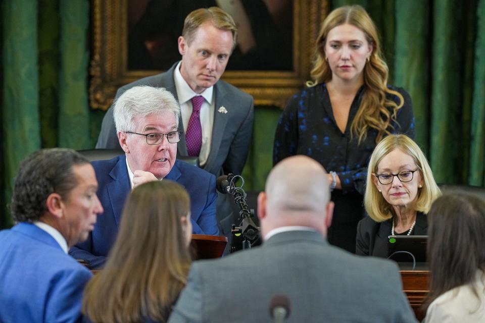 Lt. Gov. Dan Patrick, middle, talks to lawyers during the 6th day of the impeachment trial of Attorney General Ken Paxton in the Senate chamber at the Texas State Capitol in Austin on Tuesday, September 12, 2023. Paxton pleaded not guilty last week to numerous articles of impeachment.