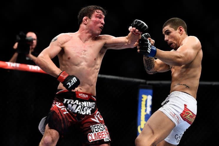 Darren Elkins punches Lucas Martins during their featherweight bout at UFC 179. (Getty)