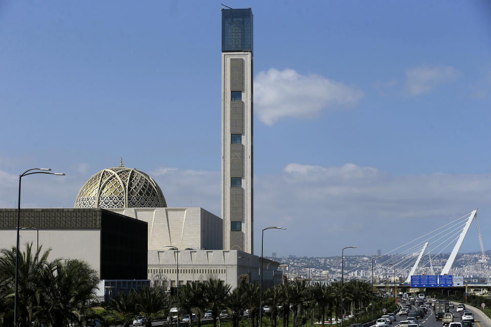 Cars drive past the The Djamaa El-Djazair, or Algiers Great Mosque, Wednesday, Feb.21, 2024 in Algiers. Begun in 2012, the Great Mosque of Algiers boasts a giant 265 meter (290 yard) minaret and a capacity for 120,000 faithful.(AP Photo/Anis Belghoul)