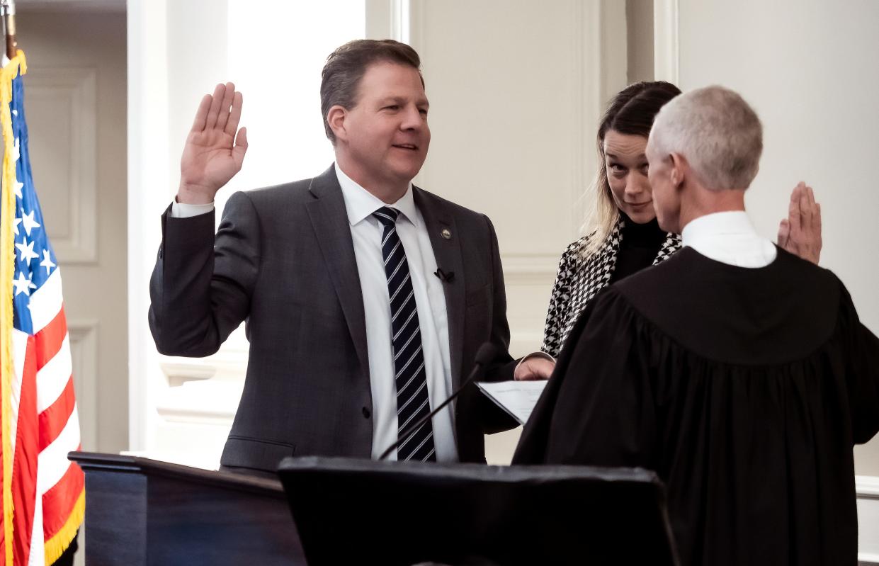 New Hampshire Gov. Chris Sununu is sworn in to serve his fourth term by state Supreme Court Chief Justice Gordon  MacDonald at Representative Hall at the State House, Thursday, Jan. 5, 2023, in Concord, N.H. First lady Valerie Sununu, center, listens.