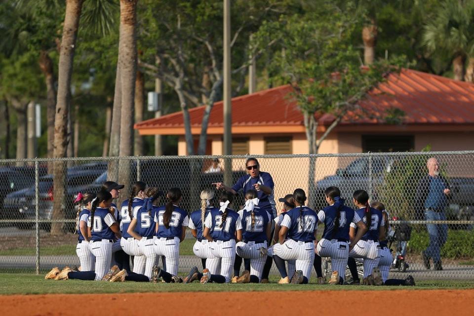 Spanish River softball head coach Ashley Byrd talks with team before game against Park Vista on Wednesday, March 13, 2024 in Lake Worth Beach.