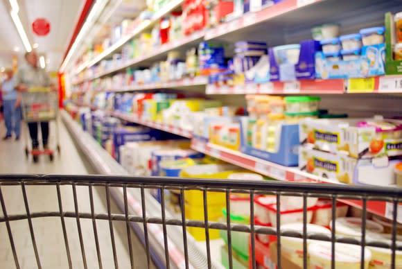 A shopping cart in an aisle at a discount store