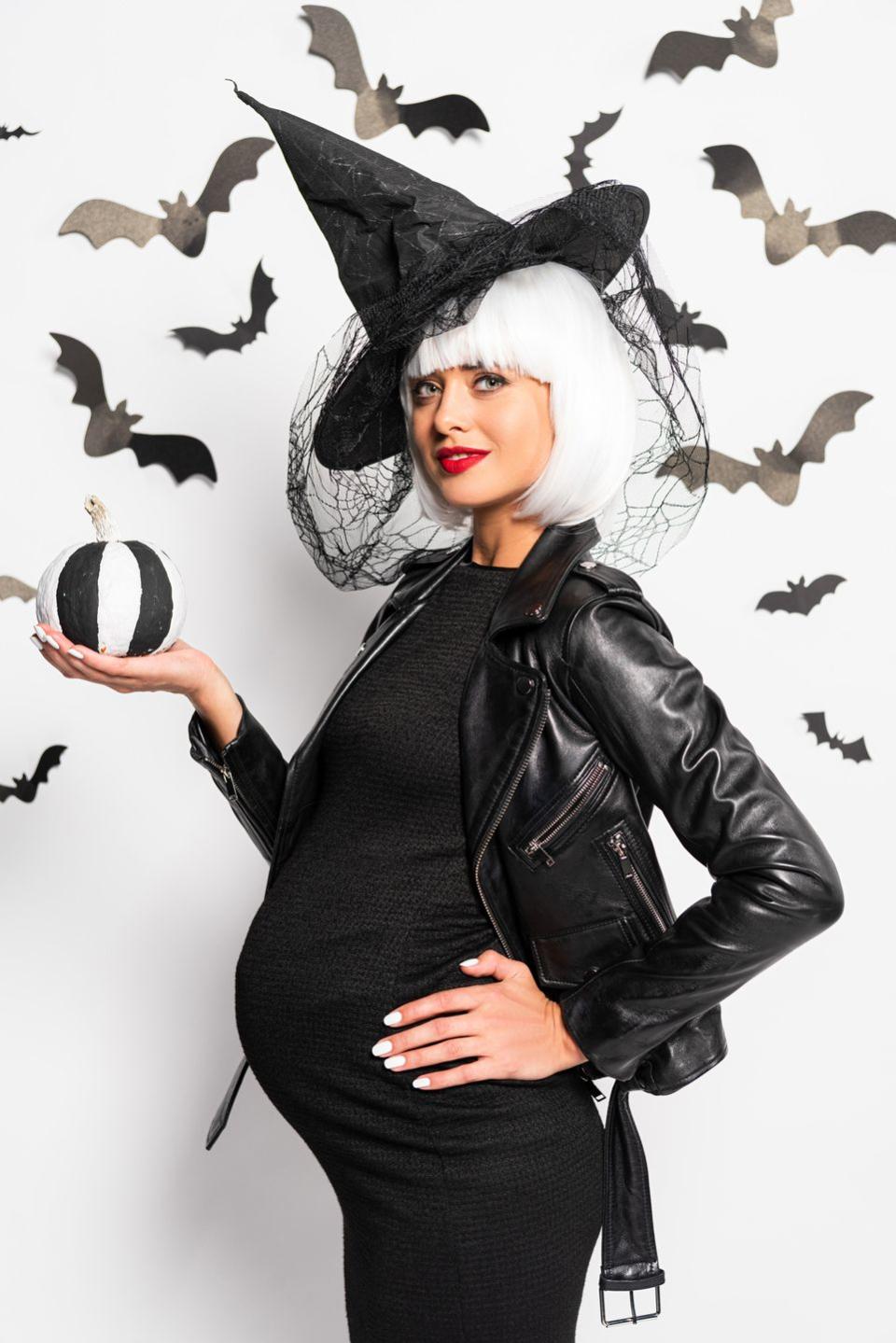 <p>You can't go wrong with a classic witch costume, especially if you're using your own comfortable <a href="https://www.amazon.com/Liu-Qu-Maternity-Sleeveless-Dresses/dp/B06XTDZLJ1/?tag=syn-yahoo-20&ascsubtag=%5Bartid%7C2140.g.41448343%5Bsrc%7Cyahoo-us" rel="nofollow noopener" target="_blank" data-ylk="slk:maternity clothes" class="link ">maternity clothes</a> as the base. Slip on your baby-friendly little black dress, plus a black <a href="https://www.amazon.com/Beistle-Satin-Soft-Black-Accessory-1-Count/dp/B000R4KNE2/?tag=syn-yahoo-20&ascsubtag=%5Bartid%7C2140.g.41448343%5Bsrc%7Cyahoo-us" rel="nofollow noopener" target="_blank" data-ylk="slk:witch's hat" class="link ">witch's hat</a>, and a wig for a spooky ensemble. If you feel like you have <em>nothing</em> to wear, we've got you covered. </p><p><a class="link " href="https://go.redirectingat.com?id=74968X1596630&url=https%3A%2F%2Fwww.walmart.com%2Fip%2FMaternity-Witch-Maternity-Costume-Maternity%2F14914296&sref=https%3A%2F%2Fwww.womenshealthmag.com%2Flife%2Fg41448343%2Fpregnant-halloween-costumes%2F" rel="nofollow noopener" target="_blank" data-ylk="slk:SHOP NOW">SHOP NOW</a></p>