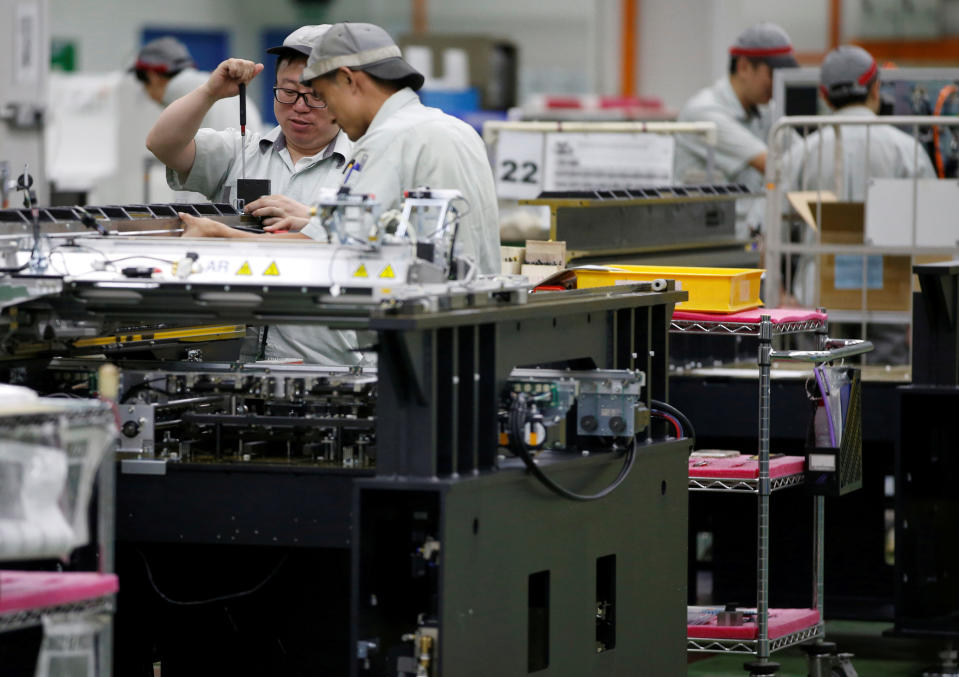 Employees at their workstations at a printed circuit board assembly factory in Singapore. (Photo: REUTERS/Edgar Su/File Photo)