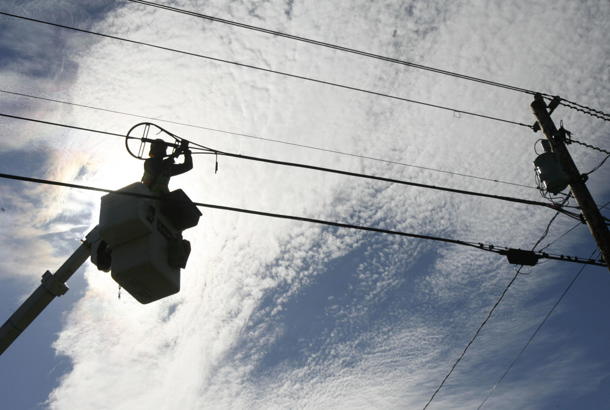 A.J. Bowen of Schupp's Line Construction, Inc. works on fiber-optic installation in Norton, Vt., Tuesday, Oct. 2, 2007. Local and state officials are planning to gather Tuesday to mark the connection of a wireless antenna on top of Town Hall to the fiber-optic Internet pipeline. With $10.5 million in federal grant money secured mainly by Sen. Patrick Leahy, D-Vt., the North-Link project is stringing 375 miles of fiber optic cable in three loops touching Vermont's eight northernmost counties. (AP Photo/Toby Talbot)