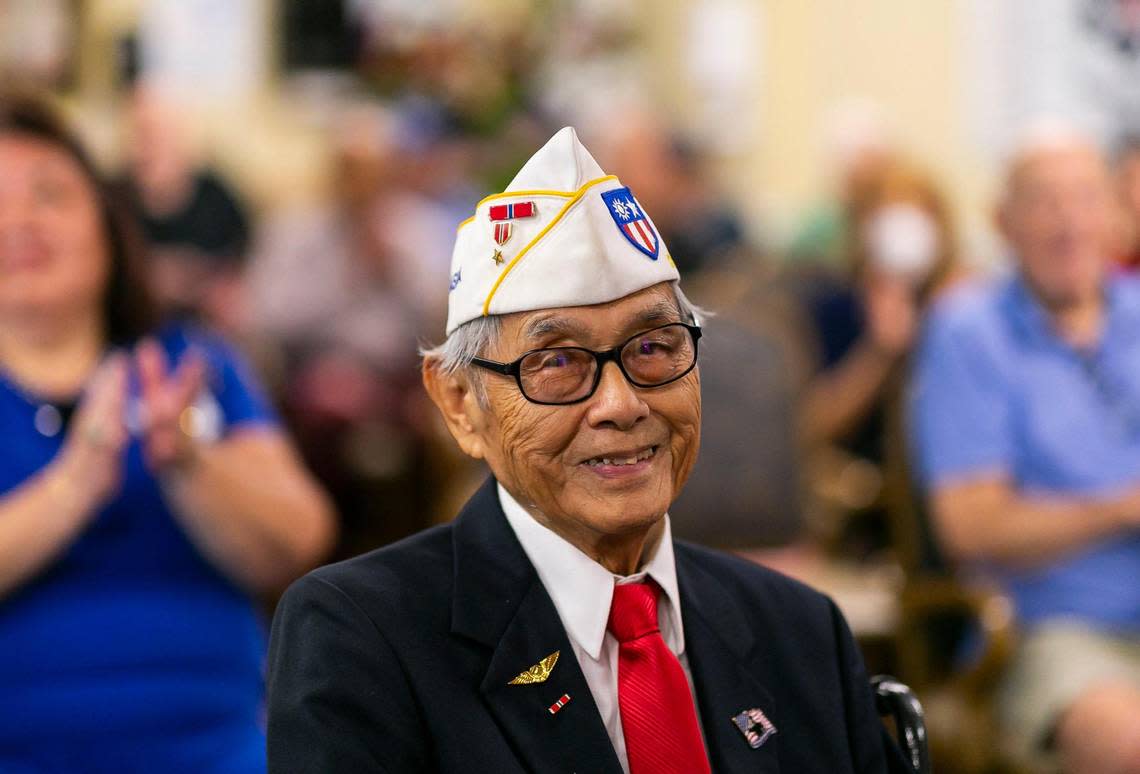 U.S. Army veteran Richard Goon, 98, center, is congratulated after receiving the Congressional Gold Medal during a virtual ceremony at the Grand Villa Senior Living Community on Tuesday, July 5, 2022, in Deerfield Beach, Fla. During his service, Goon trained as a cryptographer and eventually was stationed along the Chinese and Indochina border where he assisted American pilots and the Chinese army to fight Japanese forces.