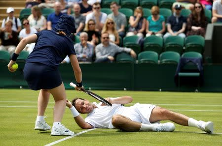 Britain Tennis - Wimbledon - All England Lawn Tennis & Croquet Club, Wimbledon, England - 28/6/16 Czech Republic's Radek Stepanek is helped up by a ball girl after slipping on court against Australia's Nick Kyrgios REUTERS/Andrew Couldridge