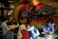 Iranians enjoy their time in a cafe in downtown Tehran, Iran, Monday, July 30, 2018. Iran's currency has dropped to a record low ahead of the imposition of renewed American sanctions, with many fearing prolonged economic suffering or possible civil unrest. (AP Photo/Ebrahim Noroozi)