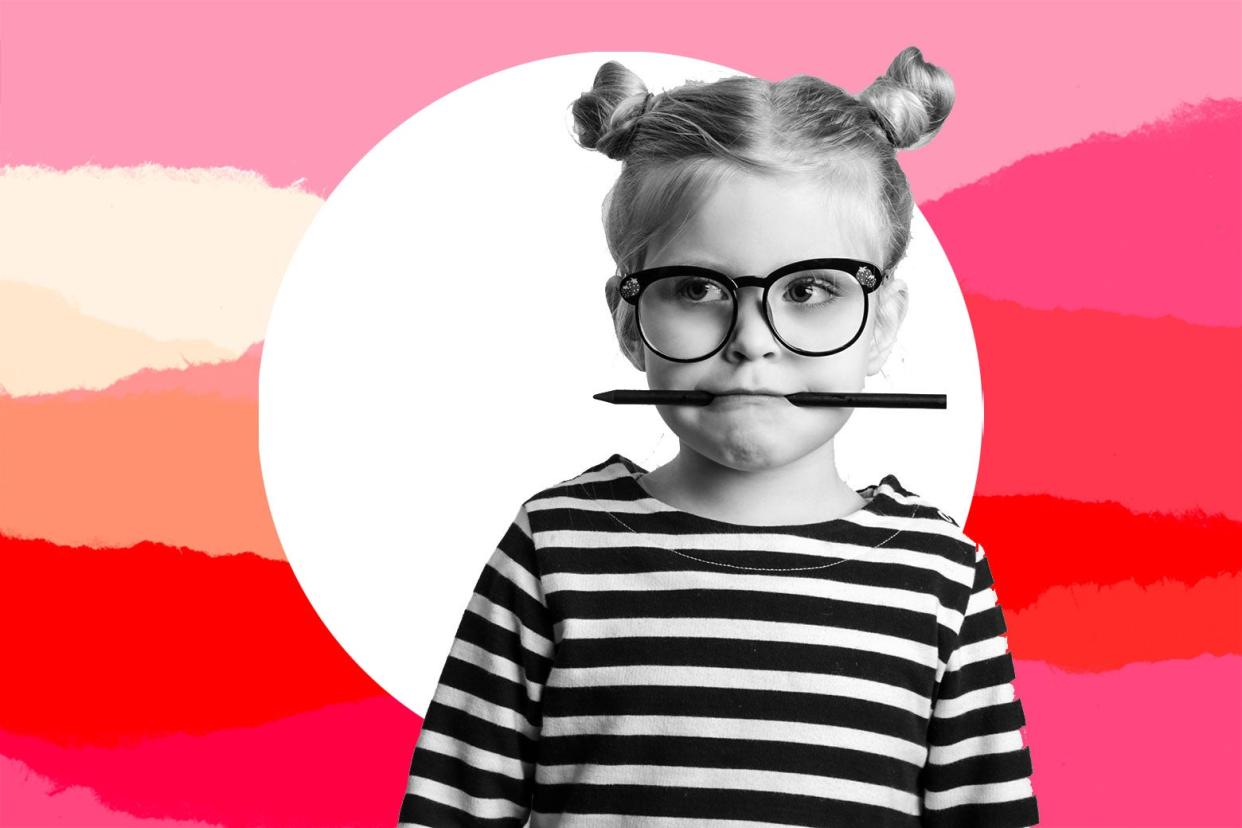Young girl with glasses and a pen.