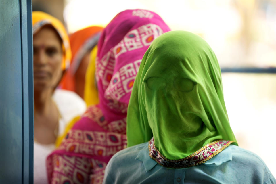 Women wait to cast their votes during the first round of voting of India's national election in Behror, Rajasthan state, India, Friday, April 19, 2024. Nearly 970 million voters will elect 543 members for the lower house of Parliament for five years, during staggered elections that will run until June 1. (AP Photo/Manish Swarup)