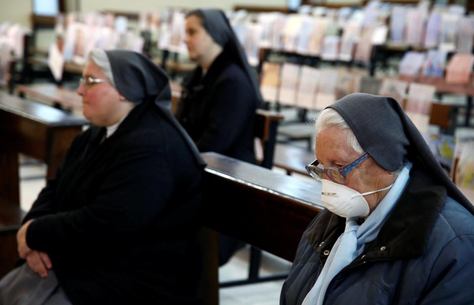 Image: Faithful attend a Holy Thursday Mass held by Father Fabio Vassallo in a nearly empty church in Catania, Italy. (ANTONIO PARRINELLO / Reuters)