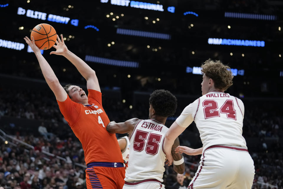 Clemson forward Ian Schieffelin (4) grabs a rebound over Alabama guard Aaron Estrada (55) during the first half of an Elite 8 college basketball game in the NCAA tournament Saturday, March 30, 2024, in Los Angeles. (AP Photo/Ashley Landis)