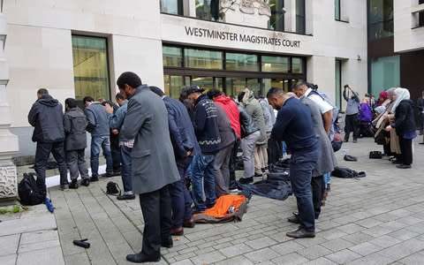 People pray outside Westminster Magistrates Court - Credit: Tess Delamare/PA