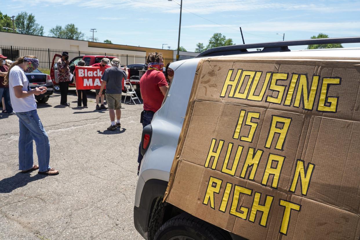 People gather at Butzel Family Center in Detroit's Islandview neighborhood with signs on their vehicles for the start of a caravan protest through Detroit neighborhoods while calling for relief for tenants and mortgage borrowers during Coronavirus pandemic on Tuesday, June 9, 2020. Detroit Eviction Defense called for the caravan in support of a new local tenant union and in anticipation of Governor Whitmer's executive order prohibiting evictions expiring at the end of this week.