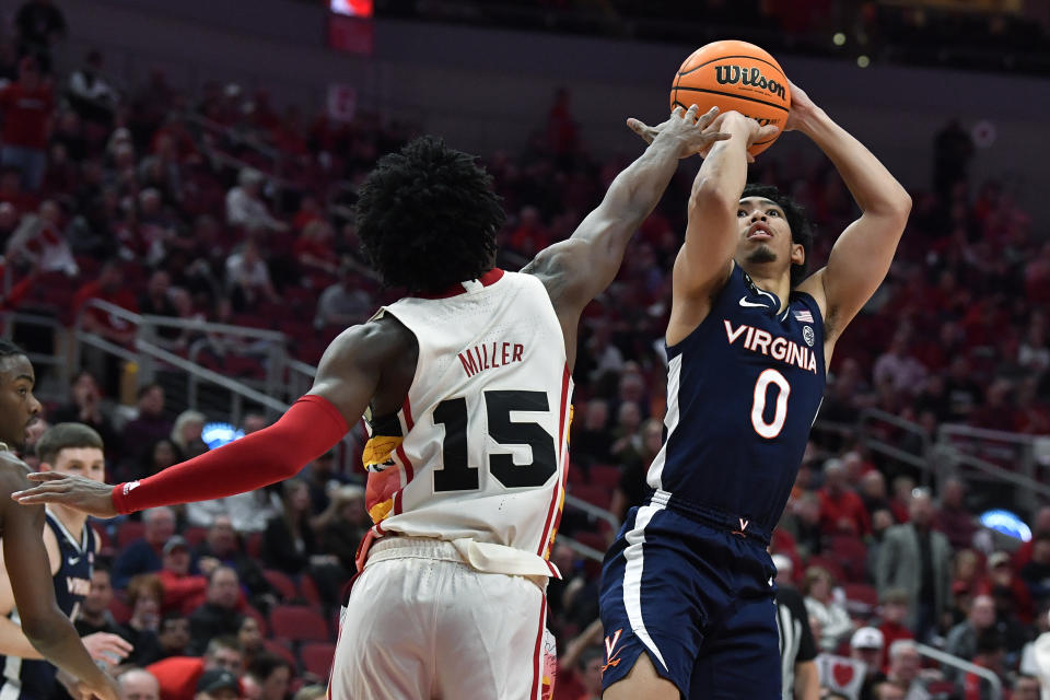 Virginia guard Kihei Clark (0) shoots over Louisville guard Hercy Miller (15) during the first half of an NCAA college basketball game in Louisville, Ky., Wednesday, Feb. 15, 2023. (AP Photo/Timothy D. Easley)