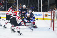 Canada's Sarah Fillier, left, shoots the puck past United States' Megan Bozek, center, and Alex Cavallini, right, for a goal during the first period of a hockey game Friday, Oct. 22, 2021, in Allentown, Pa. (AP Photo/Chris Szagola)