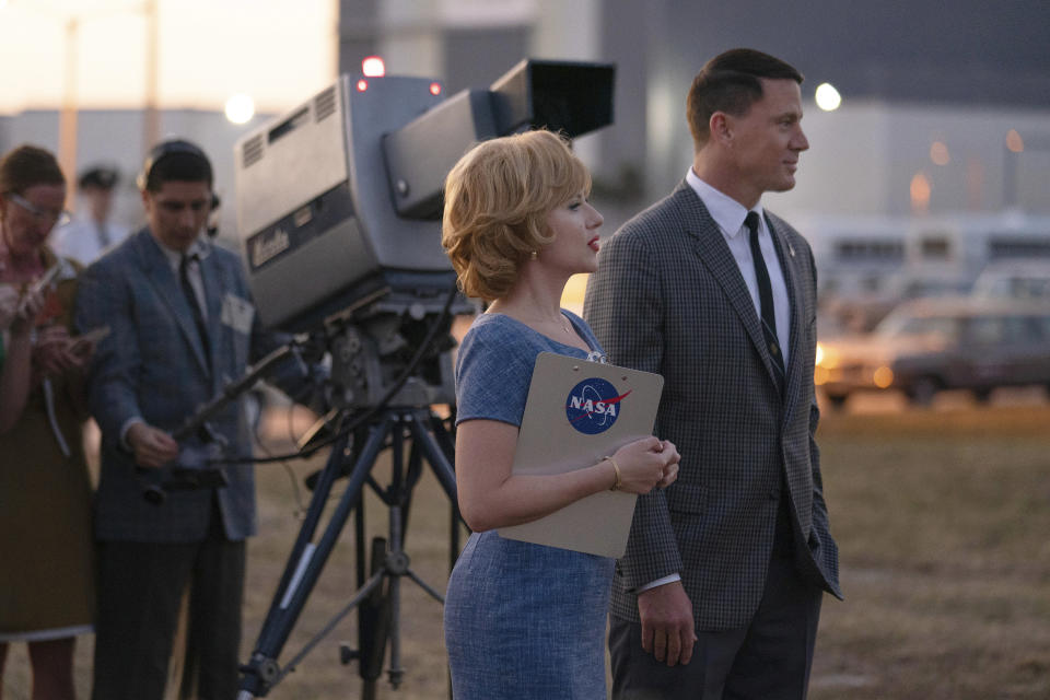 This image released by Apple TV+ shows Scarlett Johansson, center, an Channing Tatum, right, in a scene from "Fly Me to the Moon. (Dan McFadden/Apple TV+ via AP)