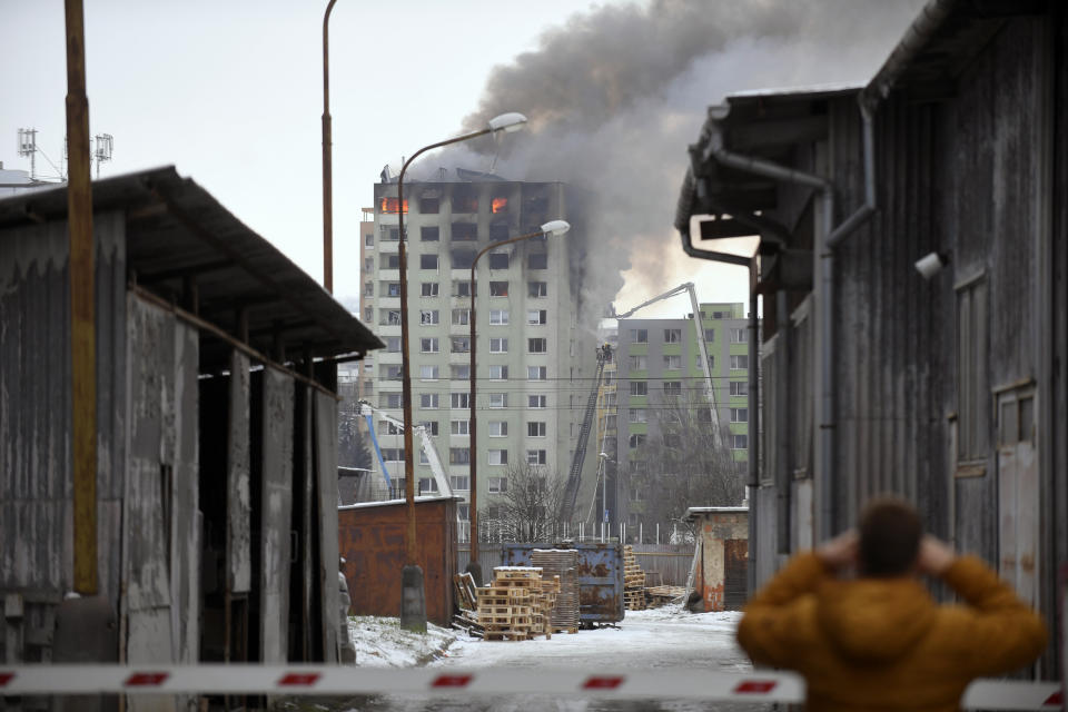 Smoke rise from a damaged 12-storey apartment block after a gas explosion in Presov, Slovakia, Friday, Dec. 6, 2019. Officials say a gas explosion in an apartment block in Slovakia has killed at least five people and others are trapped on the roof of the building. Firefighters say the explosion occurred in a 12-story building in the city of Presov shortly after noon on Friday. (Frantisek Ivan/TASR via AP)