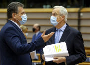 European Commission's Head of Task Force for Relations with the United Kingdom Michel Barnier, right, speaks with European Commissioner for Inter-institutional Relations and Foresight Maros Sefcovic ahead of a report of last weeks EU summit during a plenary session at the European Parliament in Brussels, Wednesday, Oct. 21, 2020. (Olivier Hoslet, Pool via AP)