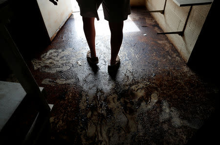 Randy Britt walks through one of his downtown buildings after flooding due to Hurricane Florence receded in Fair Bluff, North Carolina, U.S. September 29, 2018. REUTERS/Randall Hill