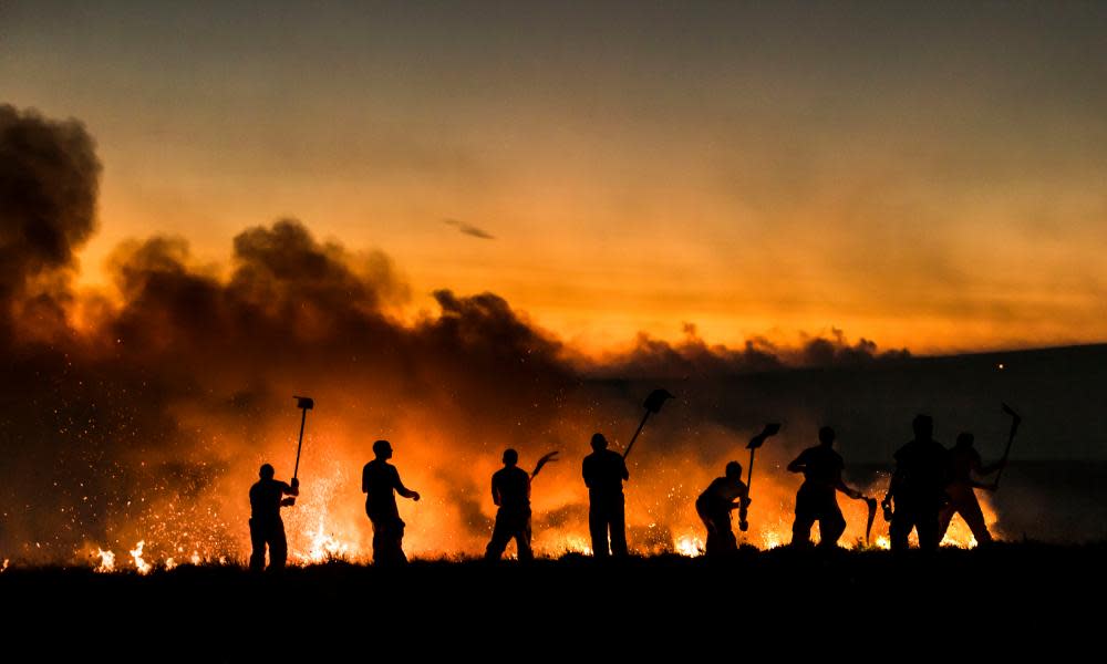 Firefighters tackle a wildfire on Winter Hill near Bolton, during the recent heatwave. 