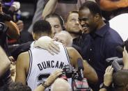 San Antonio Spurs' Tim Duncan (L) hugs coach Gregg Popovich as former Spurs champion David Robinson (R) looks on after the Spurs defeated the Miami Heat in Game 5 of their NBA Finals basketball series in San Antonio, Texas, June 15, 2014. REUTERS/Mike Stone (UNITED STATES - Tags: SPORT BASKETBALL)