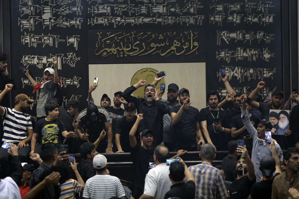 Iraqi protesters fill the parliament building in Baghdad, Iraq, Sunday, July 31, 2022. Thousands of followers of an influential Shiite cleric stormed into Iraq's parliament on Saturday, for the second time in a week, protesting government formation efforts led by his rivals, an alliance of Iran-backed groups. (AP Photo/Anmar Khalil)