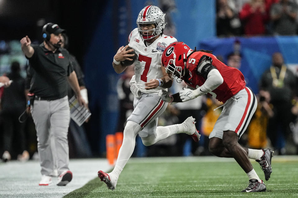 Georgia defensive back Kelee Ringo (5) hits Ohio State quarterback C.J. Stroud (7) during the first half of the Peach Bowl NCAA college football semifinal playoff game, Saturday, Dec. 31, 2022, in Atlanta. (AP Photo/John Bazemore)