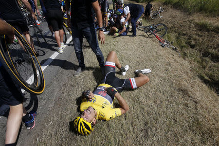 Race leader and yellow jersey holder Trek Factory rider Fabian Cancellara of Switzerland lies on the ground after a fall during the 159,5 km (99 miles) third stage of the 102nd Tour de France cycling race from Anvers to Huy, Belgium, July 6, 2015. REUTERS/Eric Gaillard