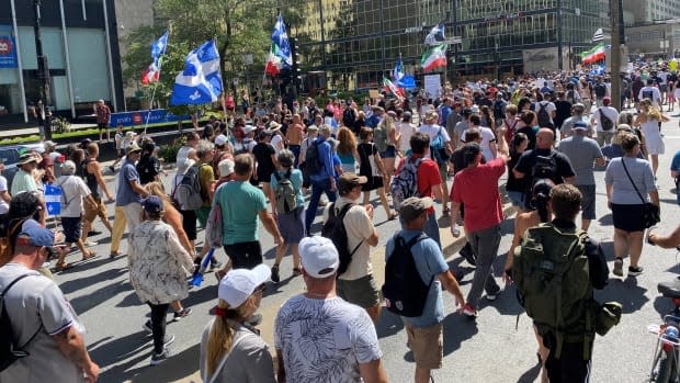 A large crowd of demonstrators gathered in downtown Montreal to protest the implementation of a vaccination passport set to be in place across Quebec on Sept. 1.  (Xavier Savard-Fournier/Radio-Canada - image credit)