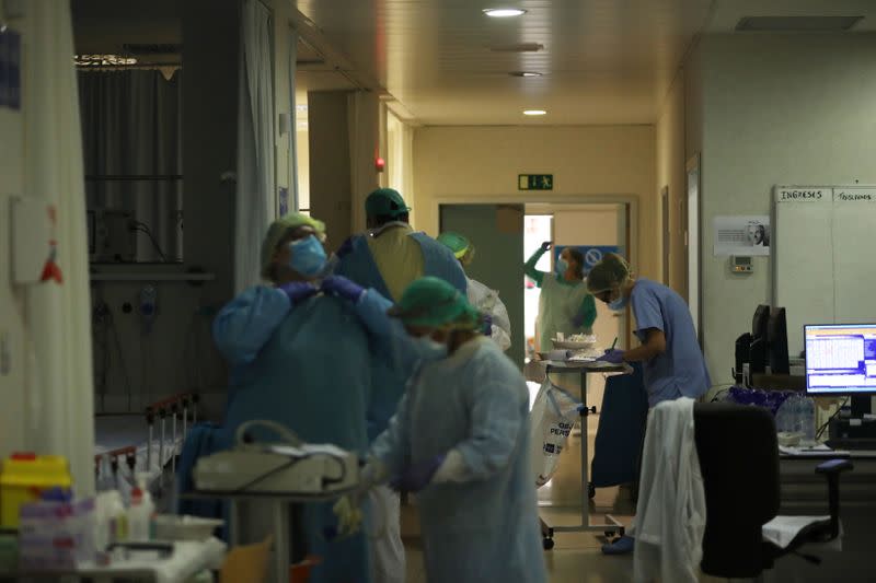 Healthcare workers in protective gear care for patients at the emergency room as the spread of the coronavirus disease (COVID-19) continues, at Infanta Sofia University hospital in Madrid