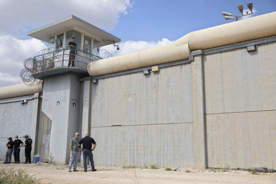 Police officers and prison guards inspect the scene of a prison escape outside the Gilboa prison in northern Israel, Monday, Sept. 6, 2021. Israeli forces on Monday launched a massive manhunt in northern Israel and the occupied West Bank after several Palestinian prisoners escaped overnight from the high-security facility in an extremely rare breakout. (AP Photo/Sebastian Scheiner)