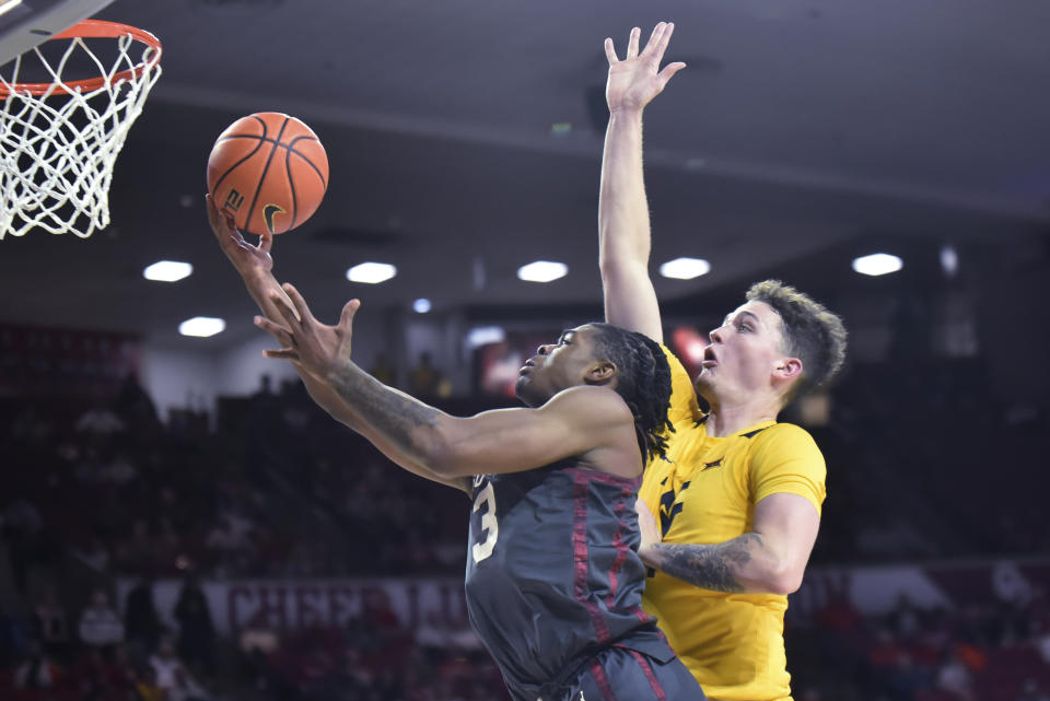 Oklahoma guard Otega Oweh shoots next to West Virginia forward Quinn Slazinski, right, during the first half of an NCAA college basketball game Wednesday, Jan. 17, 2024, in Norman, Okla. (AP Photo/Kyle Phillips)