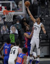 San Antonio Spurs forward Keita Bates-Diop (31) scores over Detroit Pistons center Jahlil Okafor (13) during the second half of an NBA basketball game in San Antonio, Thursday, April 22, 2021. (AP Photo/Eric Gay)