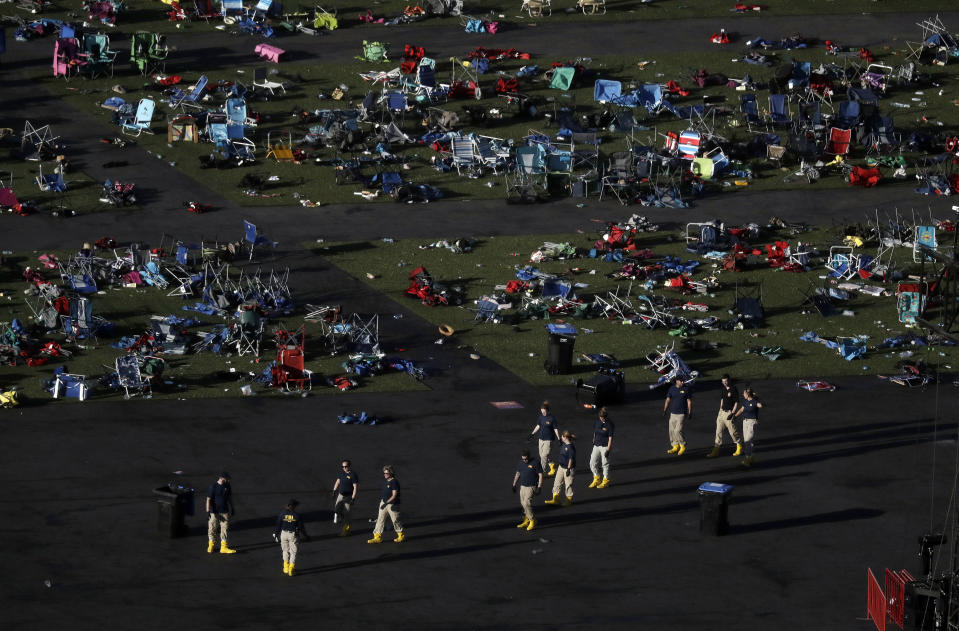 Investigators at the festival grounds across the street from the Mandalay Bay Resort and Casino on Tuesday. (Photo: Marcio Jose Sanchez/AP)